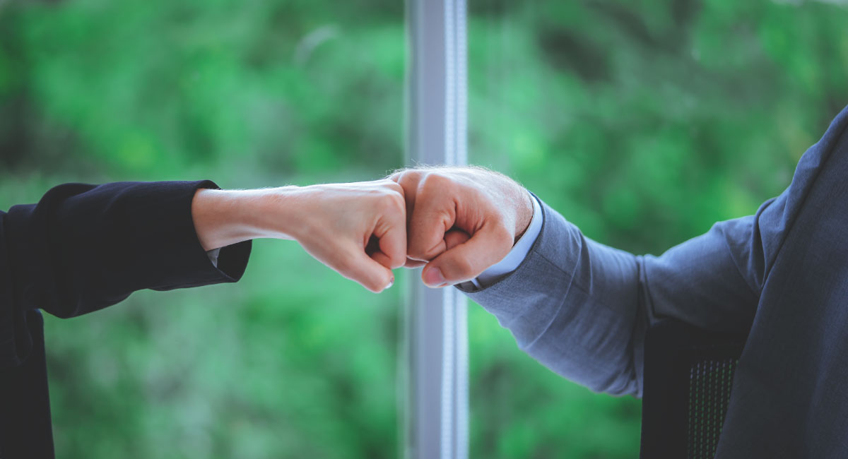 Business-IT alignment cover image - fist bump.